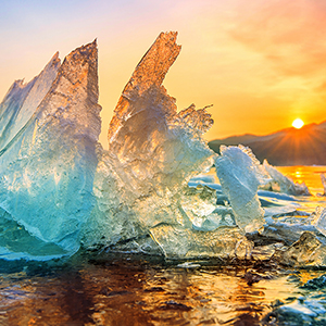 a sunset behind an iceberg